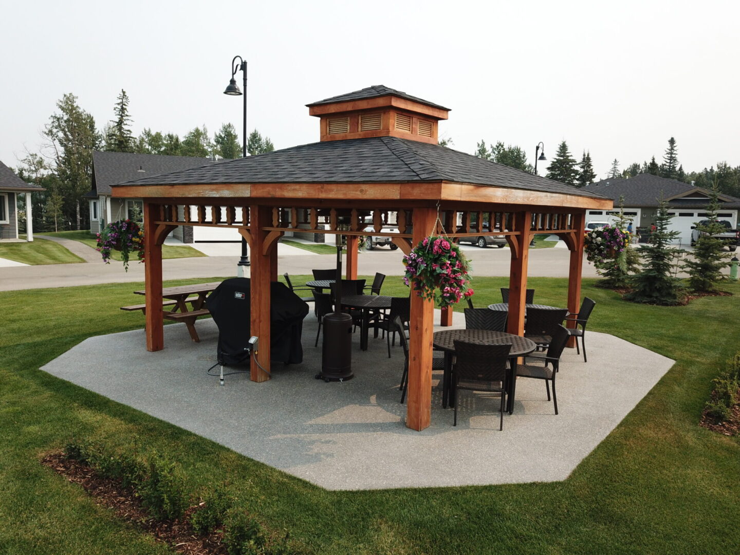 A large wooden gazebo with tables and chairs.